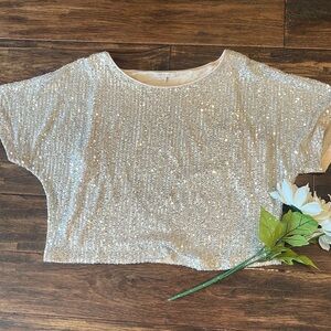 Crop sequin top or just long enough to tuck in the front. On or off 1 shoulder